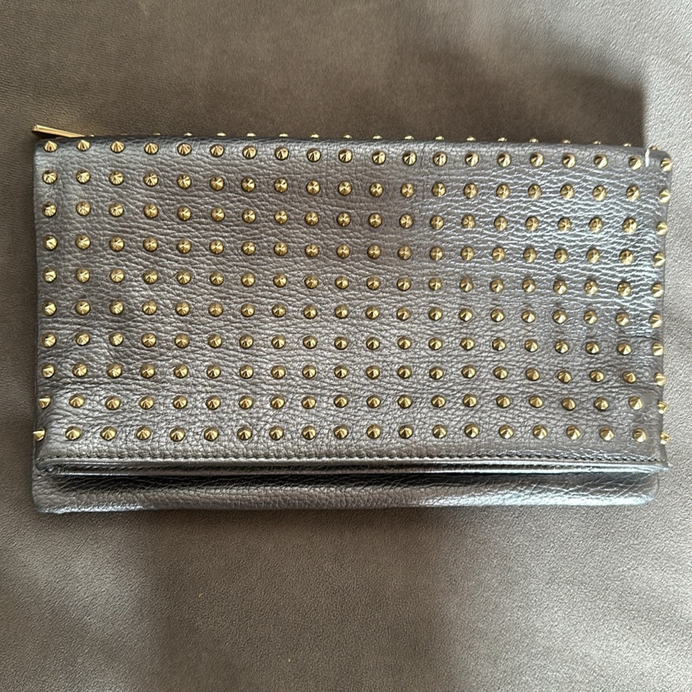 vince camino leather silver clutch with gold studs .